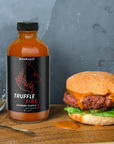 Seed Ranch Flavor Co The truffle fire hot sauce spread on a hamburger sandwich.