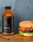 Seed Ranch Flavor Co The truffle fire hot sauce spread on a hamburger  sandwich.