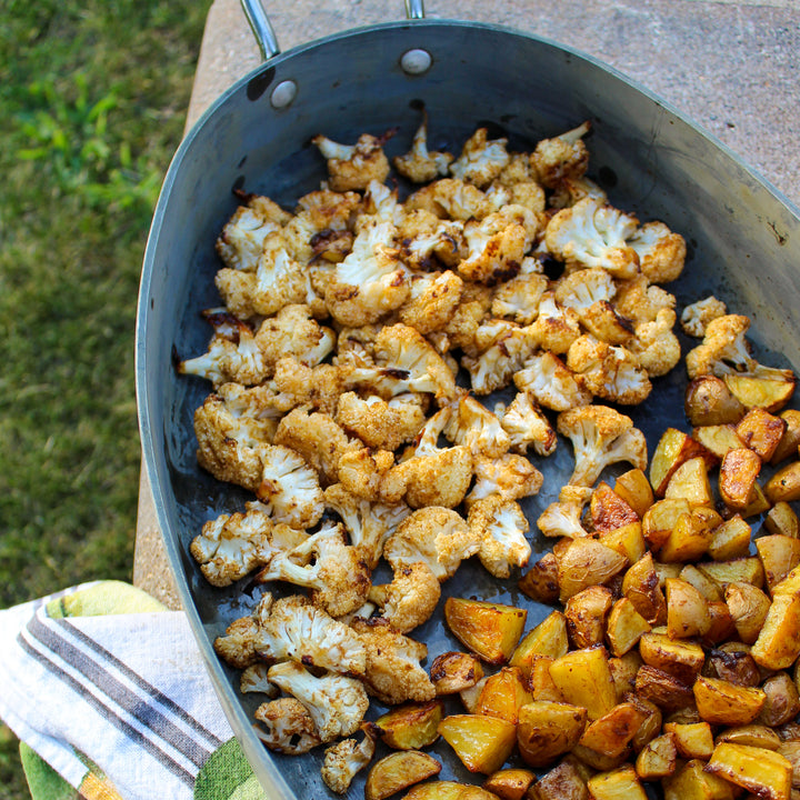 Umami roasted cauliflower and potatoes in a large dish