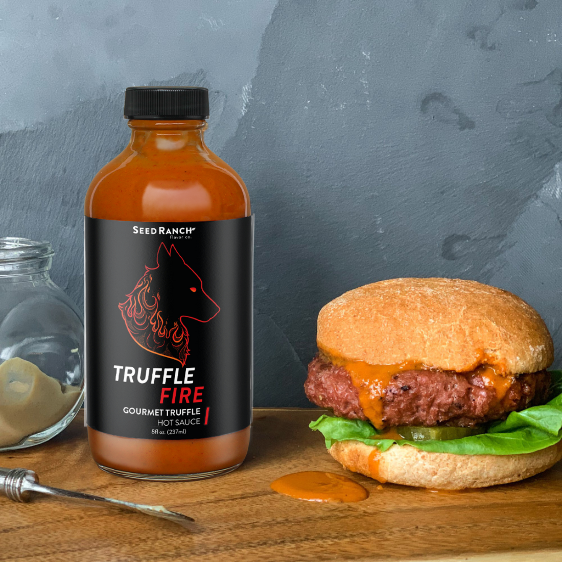 Seed Ranch Flavor Co The truffle fire hot sauce spread on a hamburger  sandwich.