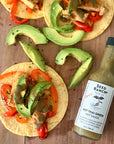 Hot Thai Green hot sauce on avocado tacos