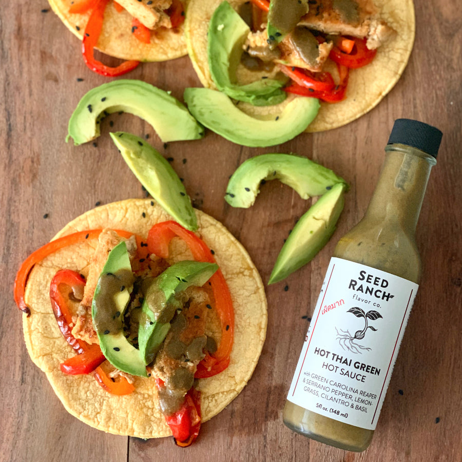 Hot Thai Green hot sauce on avocado tacos